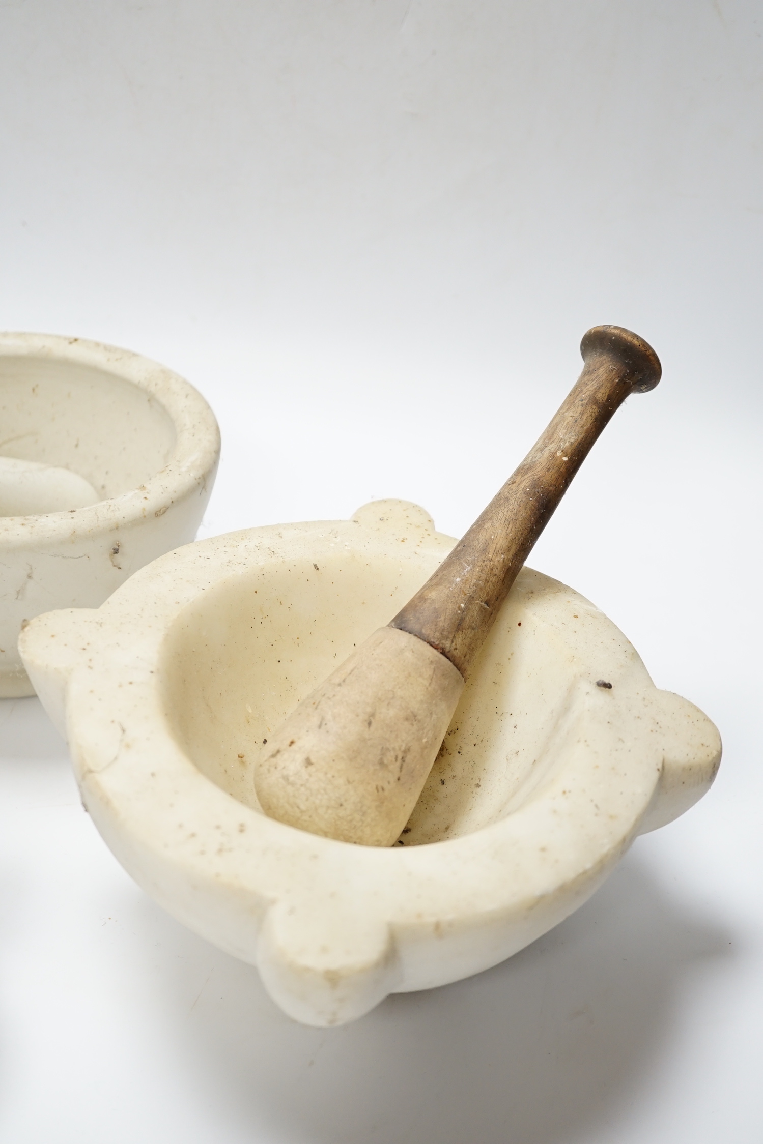 Four mortars and three pestles, largest 23cm wide